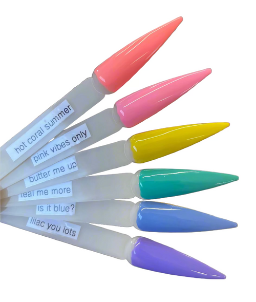 Set of colorful nail art tips with text labels on a wooden surface